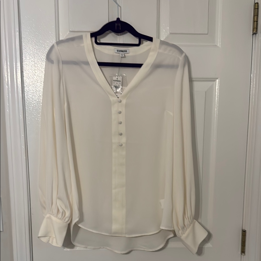Express white blouse. Never worn. Button detailing at front and cuff of top.